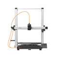 3D printer by 3dfactorylb, Anycubic Kobra 3 Max/3 Max Combo model, shown with printing bed and filament feed in a clean workspace.